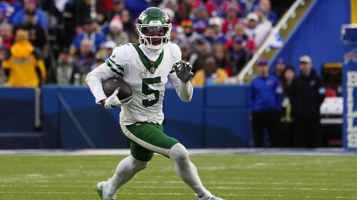 New York Jets wide receiver Garrett Wilson (5) runs with the ball after making a catch against the Buffalo Bills during the second half at Highmark Stadium.