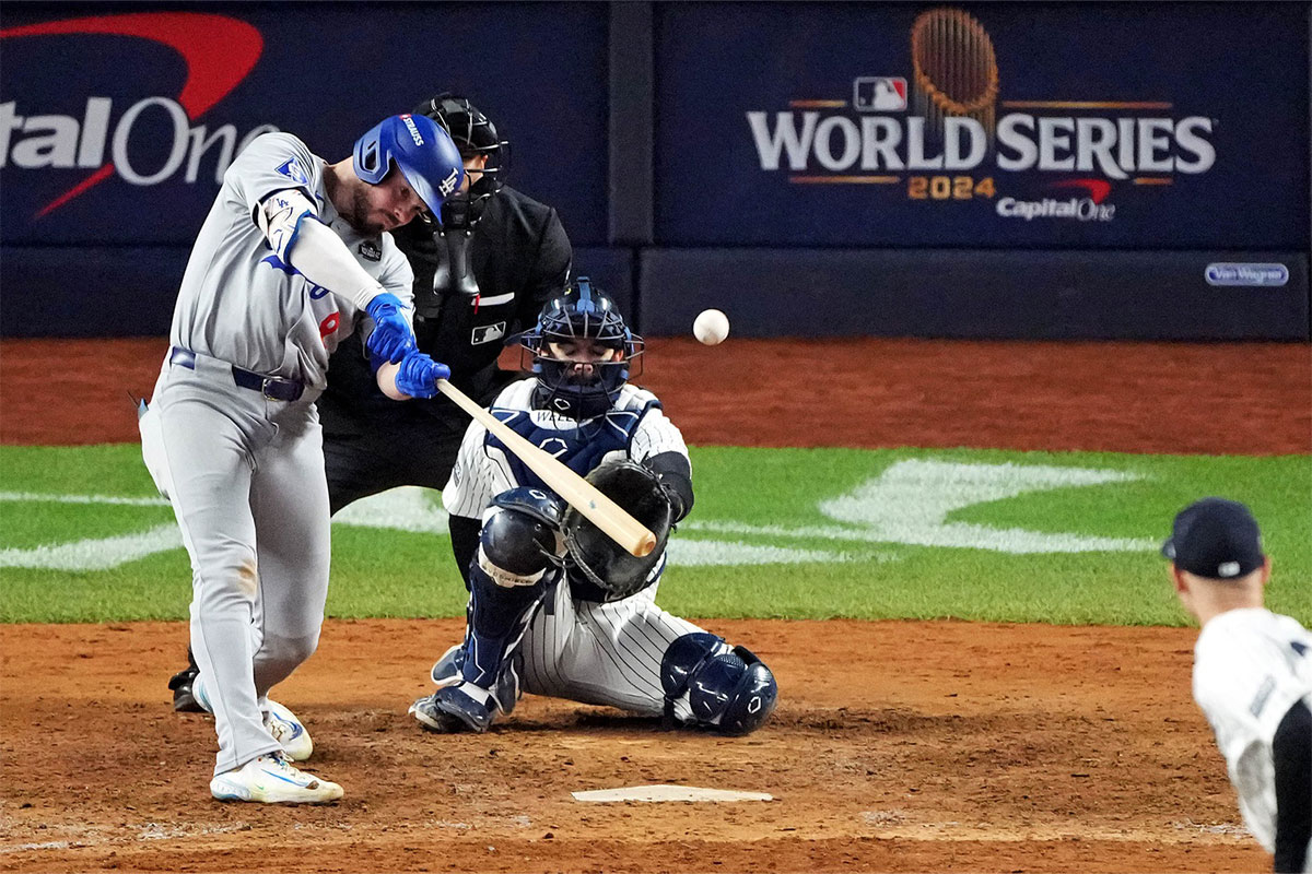 Los Angeles Dodgers second baseman Gavin Lux (9) hits a sacrifice fly during the eighth inning against the New York Yankees in game four of the 2024 MLB World Series at Yankee Stadium. 