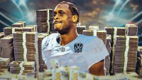 Geno Smith surrounded by piles of cash.