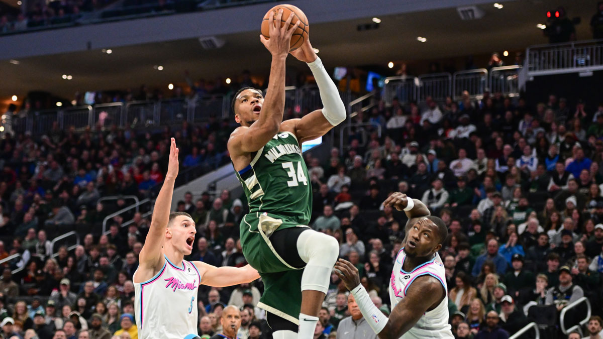 Milwaukee Bucks forward Giannis Antetokounmpo (34) takes a shot between Miami Heat forward Nikola Jovic (5) and guard Terry Rozier (2) in the second quarter at Fiserv Forum.