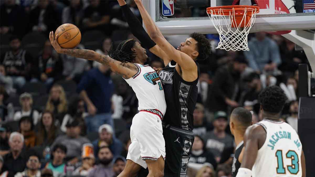 Grizzlies guard Ja Morant dunks over Spurs' Victor Wembanyama