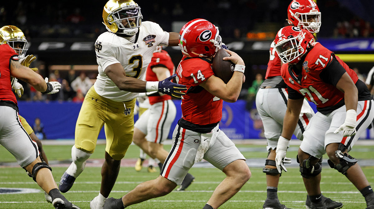 Georgia Bulldogs quarterback Gunner Stockton (14) runs with the ball during the second half against Notre Dame Fighting Irish running back Gi'Bran Payne (3) at Caesars Superdome