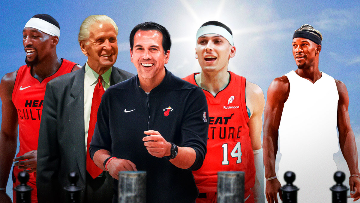 Heat coach Eric Spoelstra, GM Pat Riley, Bam Adebayo, Tyler Herrro, and Jimmy Butler (with Butler in a blank jersey) all smiling with a sunny day background