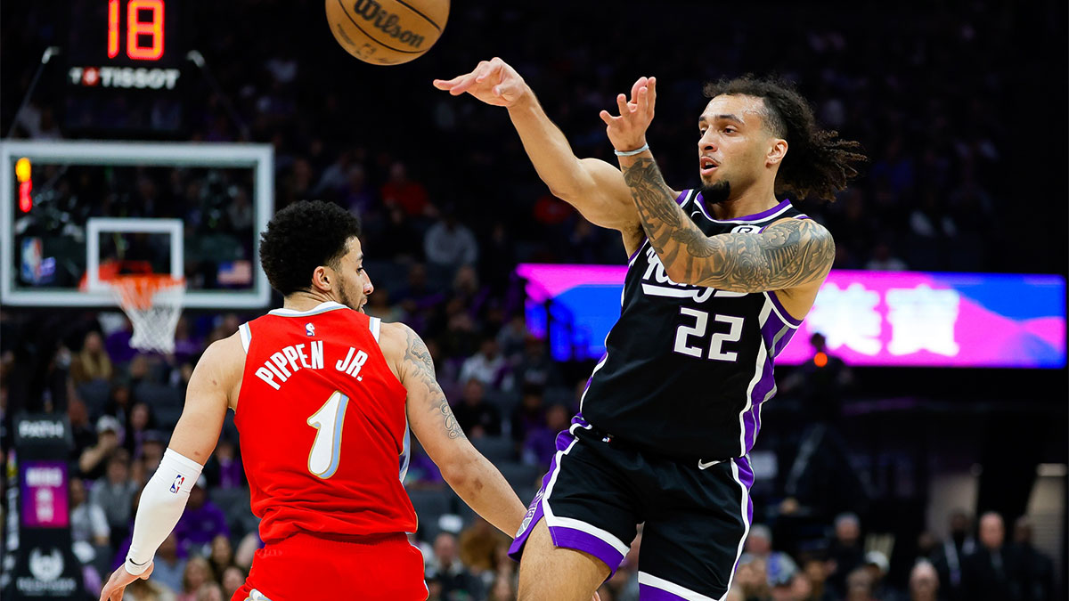 Sacramento Kings guard Devin Carter (22) passes the ball against Memphis Grizzlies guard Scotty Pippen Jr. (1) during the first quarter at Golden 1 Center.