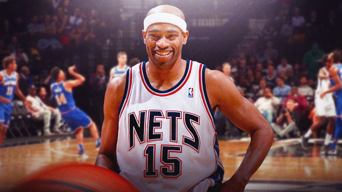 Former NBA player Vince Carter in his old Nets jersey with the Nets arena in the background, jersey retirement ceremony
