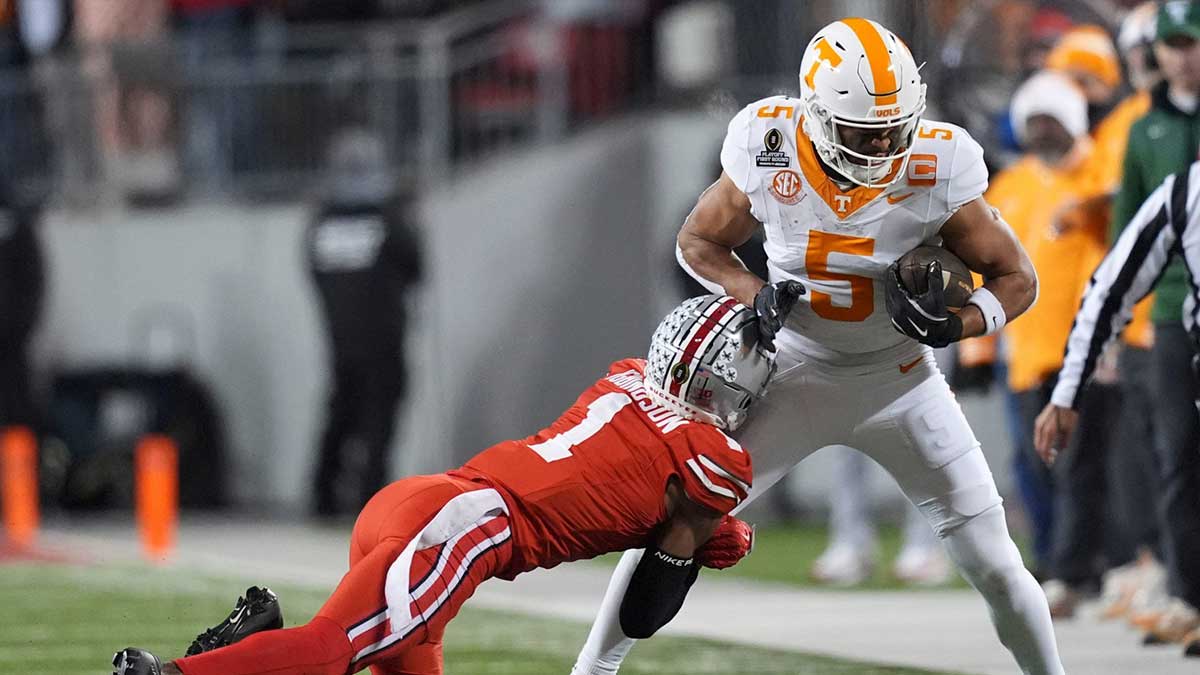Tennessee wide receiver Bru McCoy (5) is grabbed by Ohio State cornerback Davison Igbinosun (1) during an NCAA college football playoff game on Saturday, Dec. 21, 2024, in Columbus, Ohio.