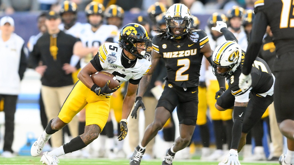 Iowa Hawkeyes wide receiver Jacob Gill (5) runs through the tackle of Missouri Tigers cornerback Toriano Pride Jr. (2) during the second half at Nissan Stadium.