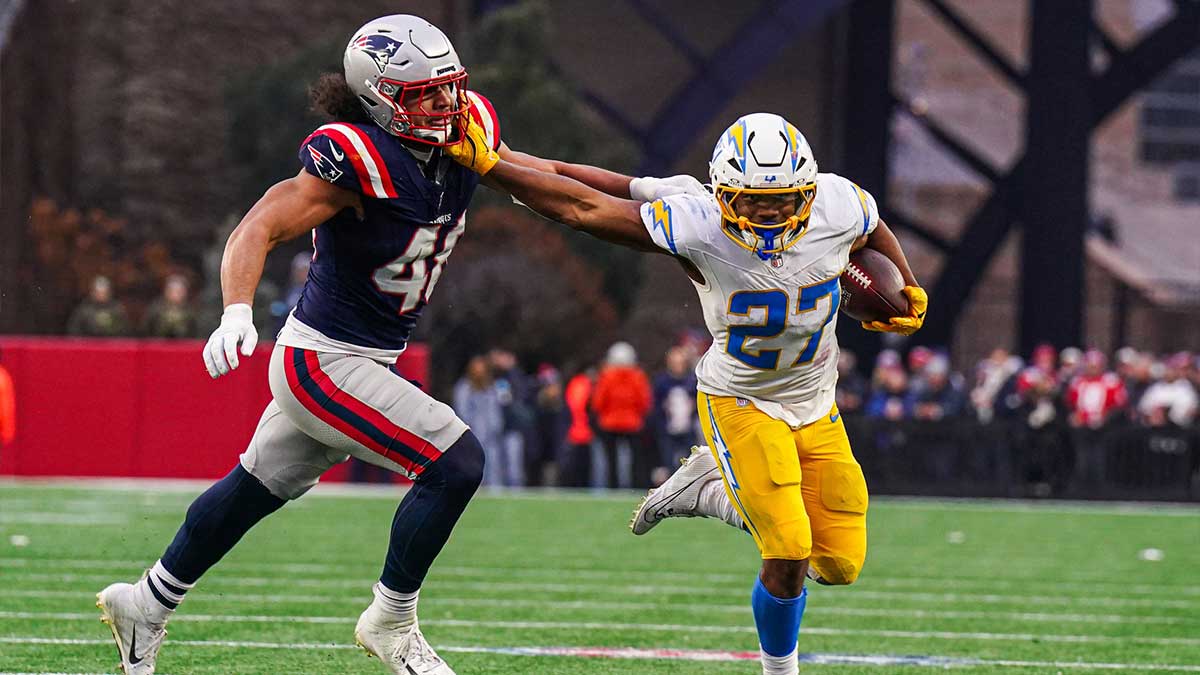 Los Angeles Chargers running back J.K. Dobbins (27) runs the ball against New England Patriots linebacker Jahlani Tavai (48) in the second half at Gillette Stadium.