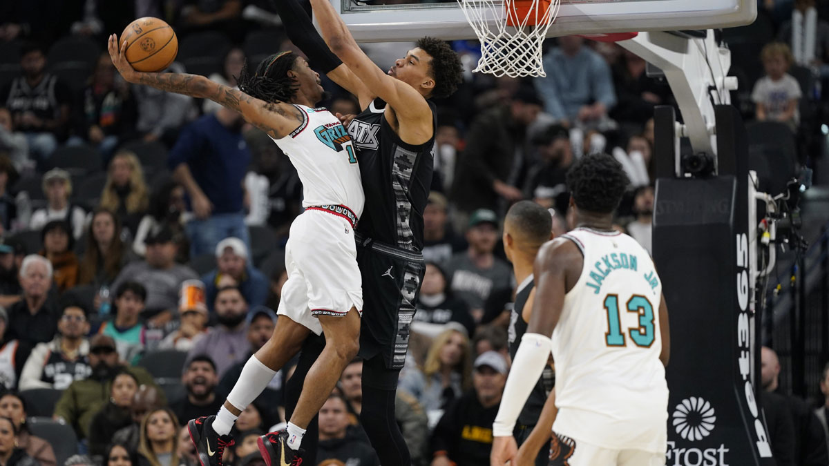 Memphis Grizzlies guard Ja Morant (12) shoots against San Antonio Spurs center Victor Wembanyama (1) during the second half at Frost Bank Center.