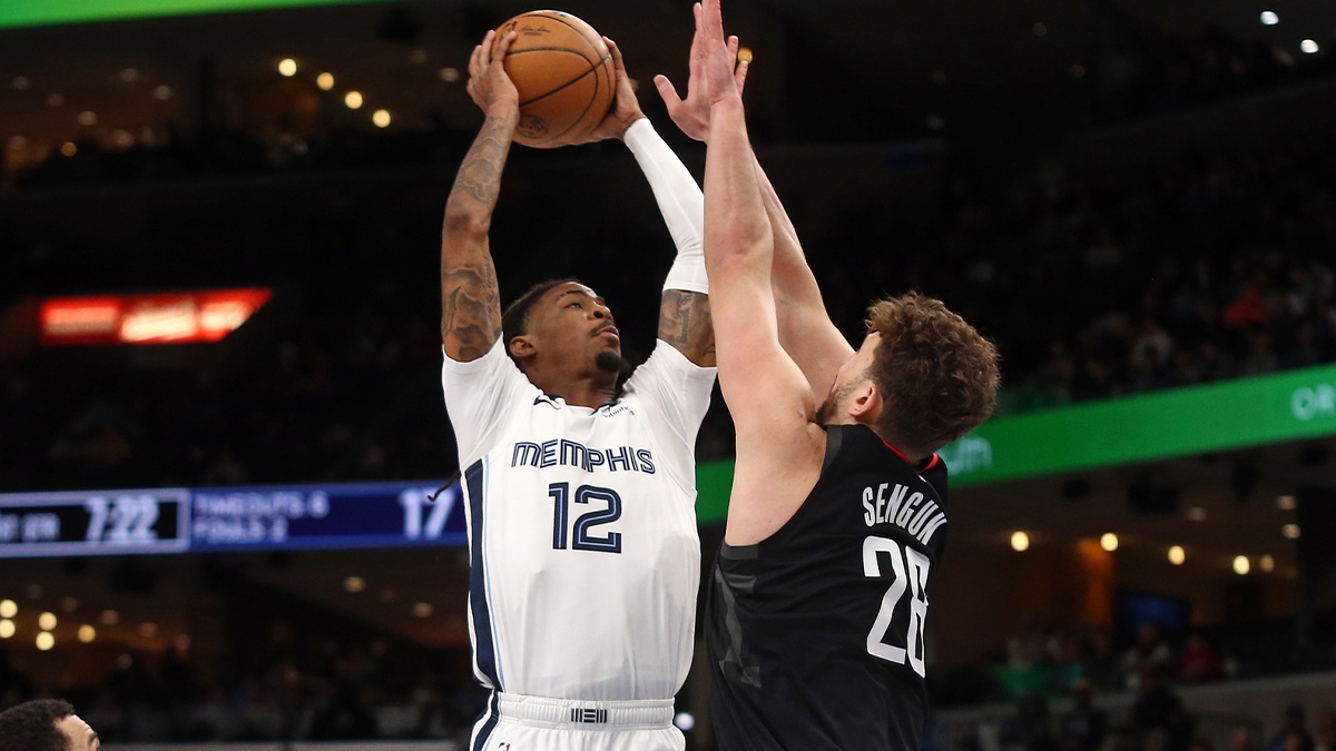 Memphis Grizzlies guard Ja Morant (12) drives to the basket as Houston Rockets center Alperen Sengun (28) defends during the first quarter at FedExForum.