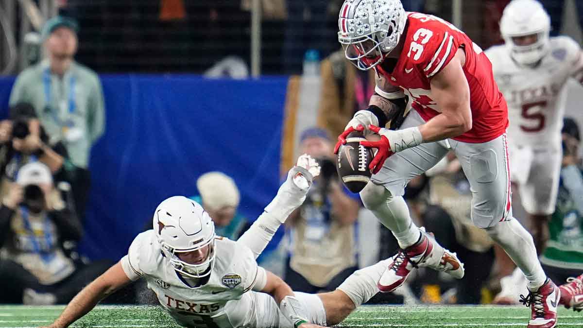 Ohio State Buckeyes defensive end Jack Sawyer (33) sacks Texas Longhorns quarterback Quinn Ewers (3) forcing a fumble during the second half of the Cotton Bowl Classic College Football Playoff semifinal game at AT&T Stadium in Arlington, Texas on Jan. 10, 2025. Sawyer returned the fumble for a touchdown, and Ohio State won 28-14.