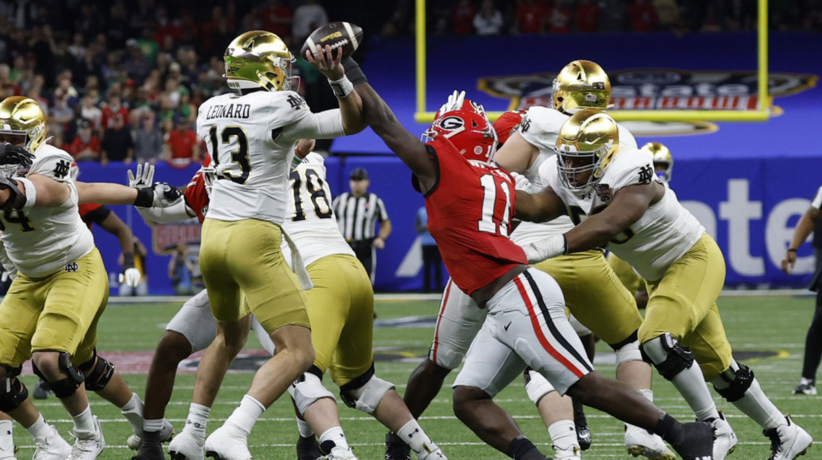 Notre Dame Fighting Irish quarterback Riley Leonard (13) passes the ball as George Bulldogs running back Jaylon Walker (11) defends during the first quarter at Caesars Superdome. 