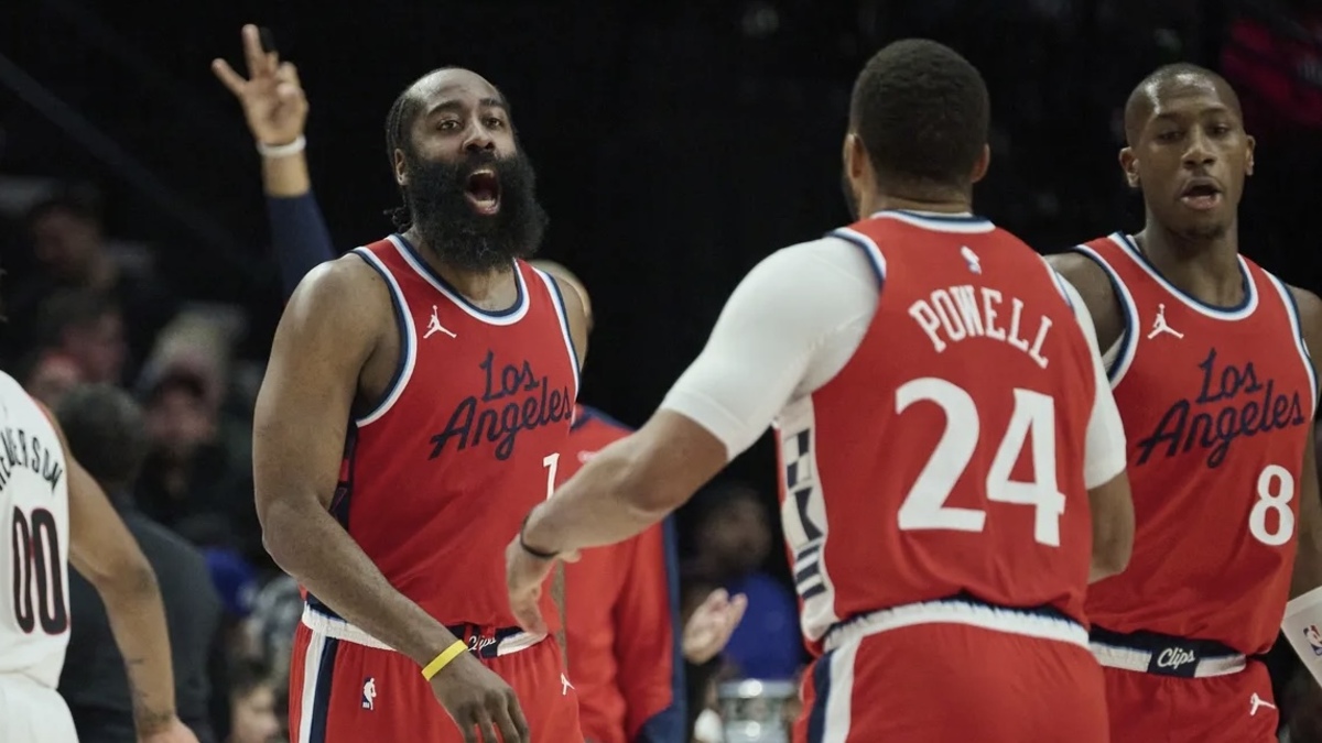 LA Clippers guard James Harden (1) celebrates with guard Norman Powell (24) after scoring a three point basket during the second half against the Portland Trail Blazers at Moda Center.