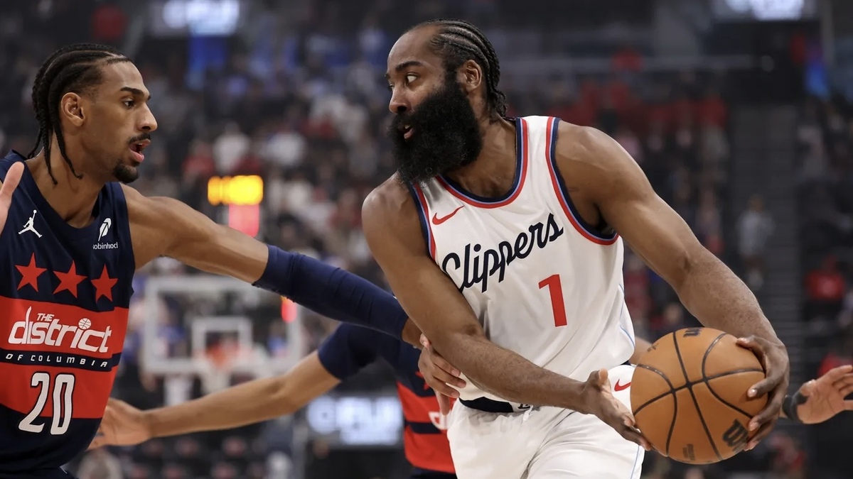 Los Angeles Clippers guard James Harden (1) is defended by Washington Wizards forward Alex Sarr (20) during the first quarter at the Intuit Dome.