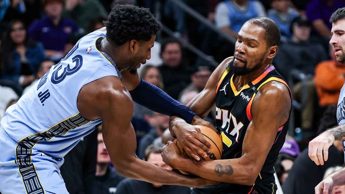 Memphis Grizzlies forward-center Jaren Jackson Jr. (13) attempts to take the ball from Phoenix Suns forward Kevin Durant (35) during the third quarter of the game at Footprint Center.