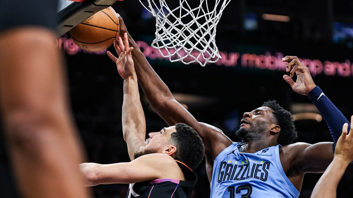 Phoenix Suns guard Devin Booker (1) attempts to make a lay up while Memphis Grizzlies forward-center Jaren Jackson Jr. (13) blocks him during the fourth quarter of the game at Footprint Center.