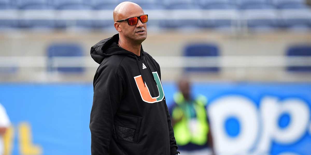 Dec 28, 2024; Orlando, FL, USA; Miami Hurricanes defensive line coach Jason Taylor walks on the field prior to the game against the Iowa State Cyclones at Camping World Stadium. Mandatory Credit: Jasen Vinlove-Imagn Images