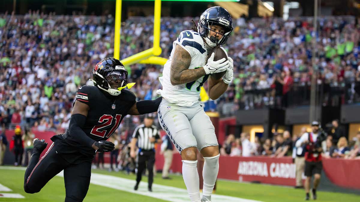 Seattle Seahawks wide receiver Jaxon Smith-Njigba (11) catches a touchdown pass against Arizona Cardinals cornerback Garrett Williams (21) in the first half at State Farm Stadium.