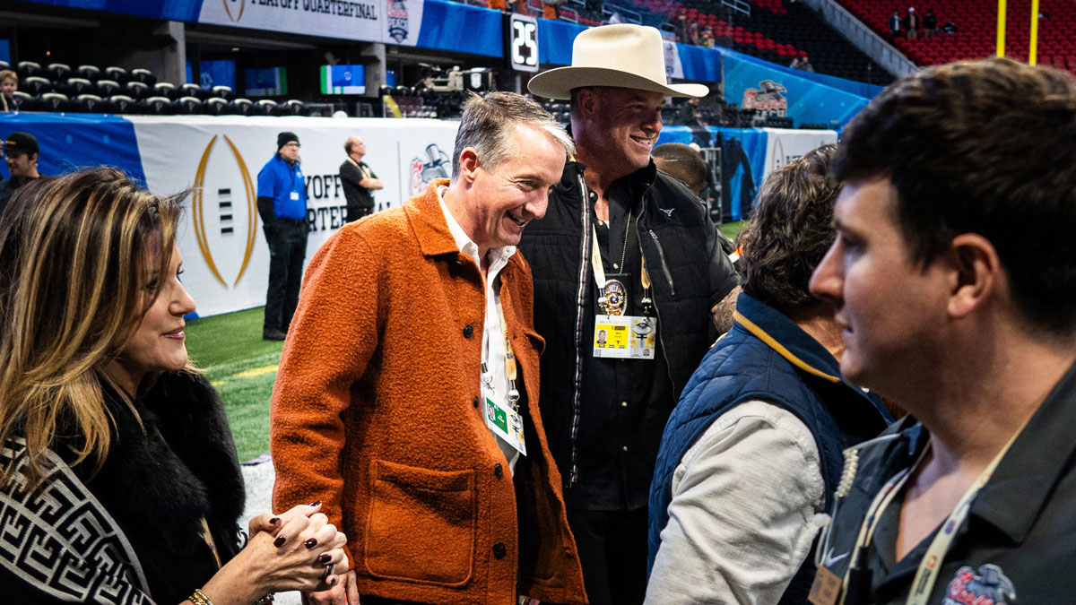 University of Texas President Jay Hartzell walks onto the field as the Texas Longhorns prepare to play the Arizona State Sun Devils in the Peach Bowl College Football Playoff quarterfinal at Mercedes-Benz Stadium in Atlanta, Georgia, Jan. 1, 2025.