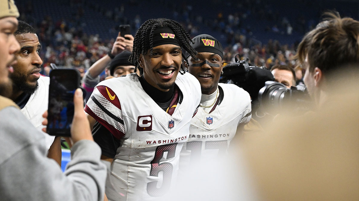 Washington Commanders quarterback Jayden Daniels (5) and wide receiver Terry McLaurin (17) celebrate the win against Detroit Lions in a 2025 NFC divisional round game at Ford Field.