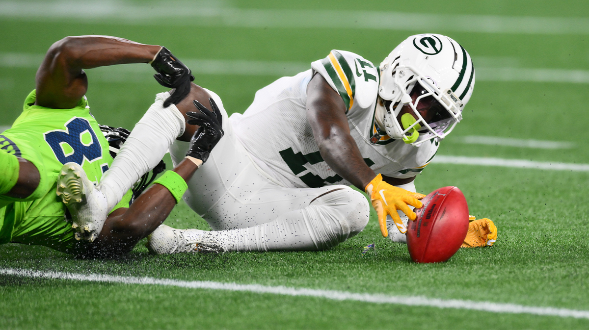 Green Bay Packers specialist Jayden Reed (11) recovers his own fumble during a punt in the second half against the Seattle Seahawks at Lumen Field. 