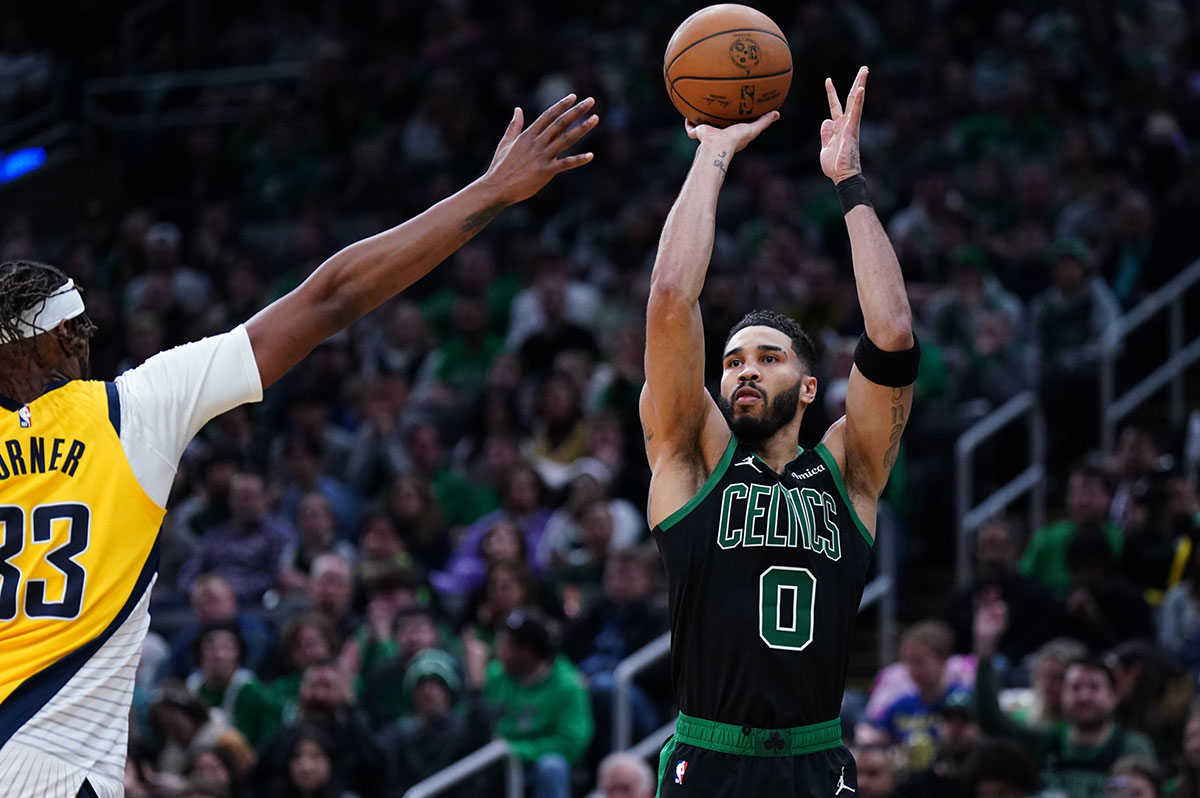 Boston Celtics forward Jayson Tatum (0) shoot for three points against Indiana Pacers center Myles Turner (33) in the second quarter at TD Garden.