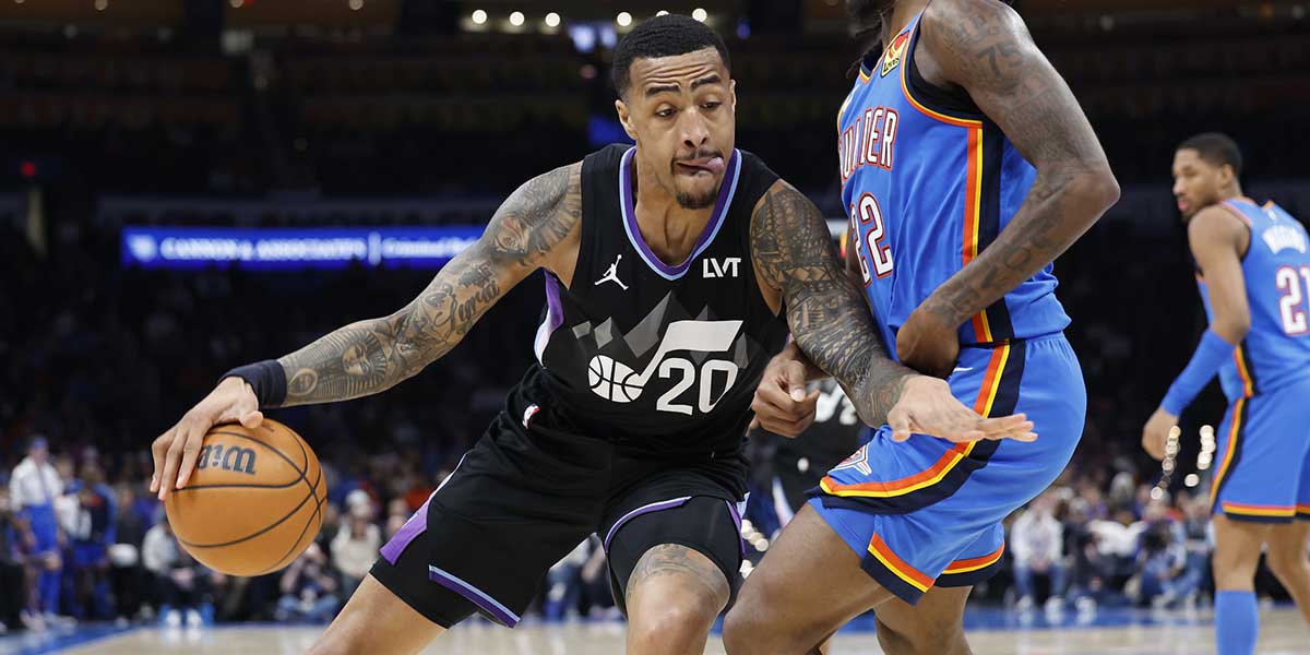 Jazz forward John Collins (20) drives against Oklahoma City Thunder guard Cason Wallace (22) during the second half at Paycom Center