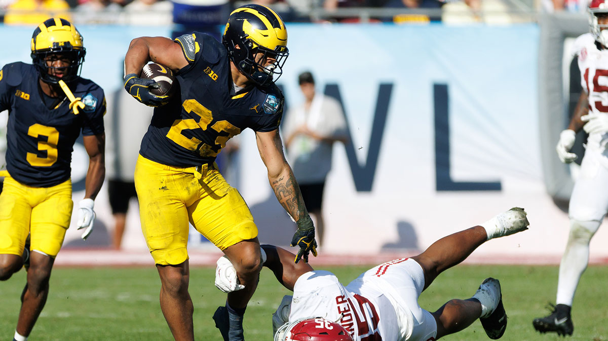 Dec 31, 2024; Tampa, FL, USA; Michigan Wolverines running back Jordan Marshall (23) pushes off on Alabama Crimson Tide linebacker Jeremiah Alexander (35) during the second half at Raymond James Stadium. Mandatory Credit: Matt Pendleton-Imagn Images