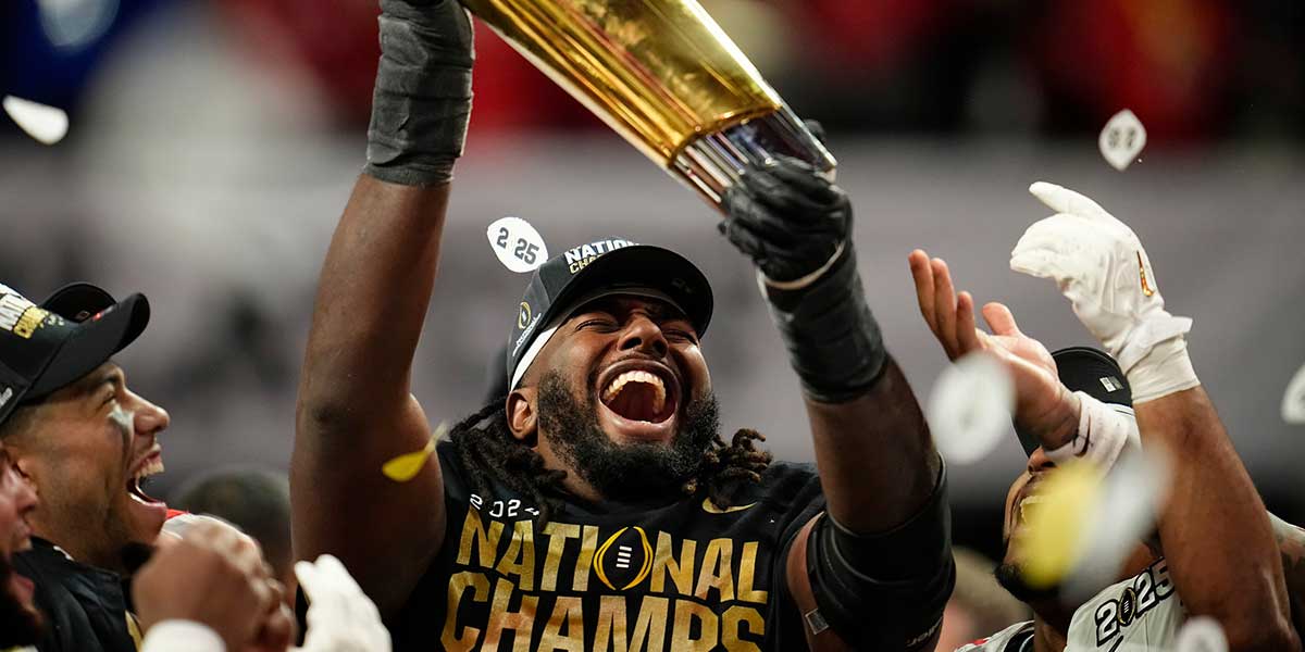 Ohio State Buckeyes wide receiver Jeremiah Smith (4) holds the trophy following the 34-23 win over the Notre Dame Fighting Irish to win the College Football Playoff National Championship at Mercedes-Benz Stadium in Atlanta on Jan. 21, 2025.