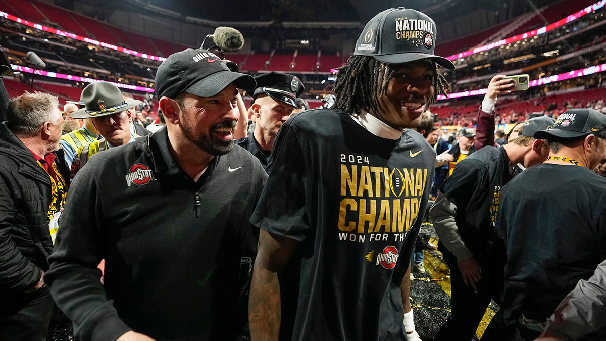 Ohio State Buckeyes head coach Ryan Day and Ohio State Buckeyes wide receiver Jeremiah Smith (4) leave the field following the 34-23 win over the Notre Dame Fighting Irish to win the College Football Playoff National Championship at Mercedes-Benz Stadium