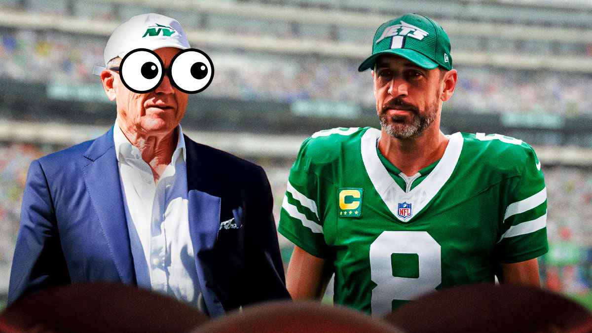 Woody Johnson (with bulging eyes) looks at Aaron Rodgers
