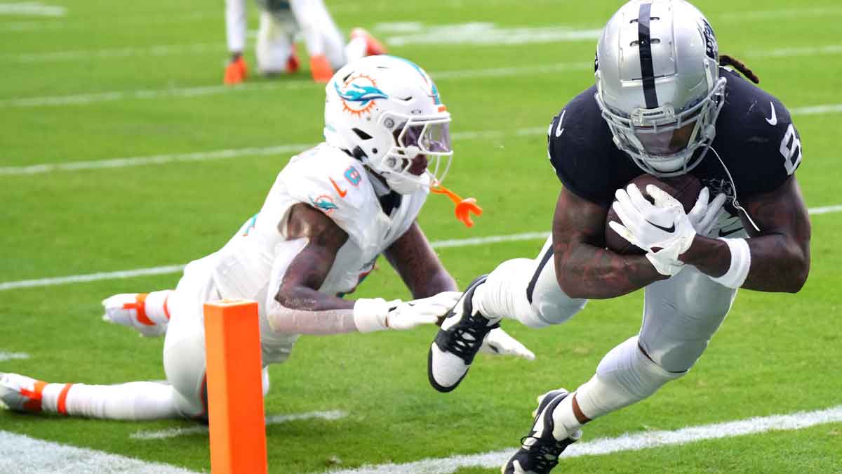 Las Vegas Raiders running back Ameer Abdullah (8) scores a touchdown past Miami Dolphins safety Jevon Holland (8) in the fourth quarter at Hard Rock Stadium.