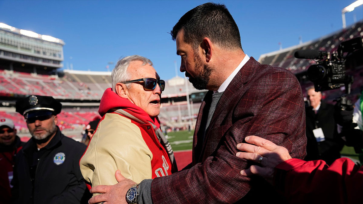 Ohio State Buckeyes head coach Ryan Day hugs former head coach Jim Tressel prior to the NCAA football game against the Michigan Wolverines at Ohio Stadium in Columbus on Saturday, Nov. 30, 2024.