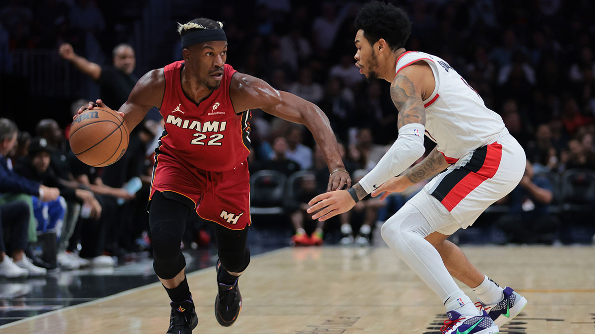 Miami Heat forward Jimmy Butler (22) drives to the basket past Portland Trail Blazers guard Anfernee Simons (1) during the first quarter at Kaseya Center.