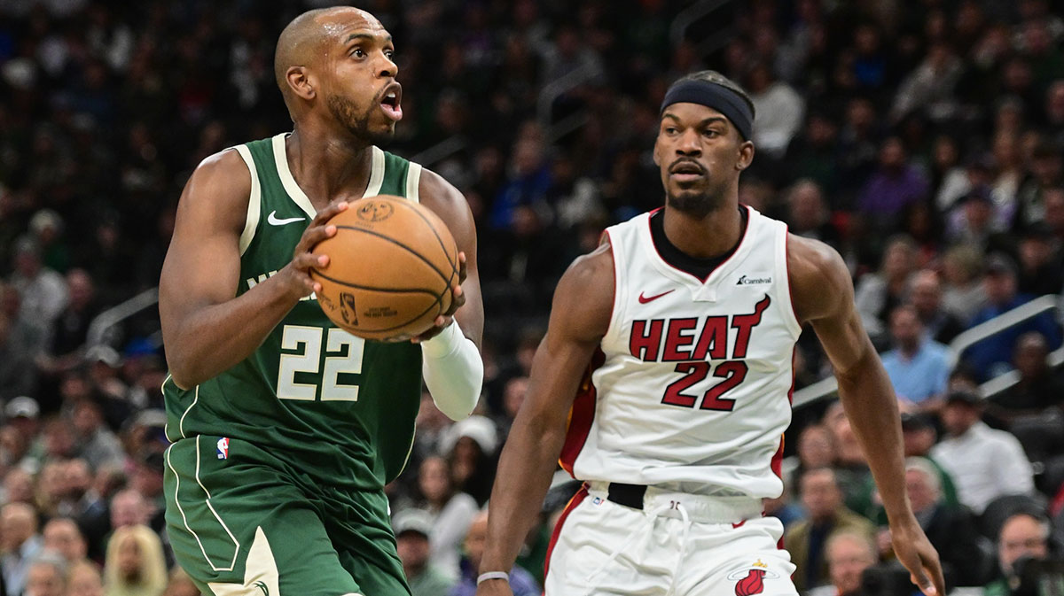 Milwaukee Bucks center Khris Middleton (22) takes a shot against Miami Heat center Jimmy Butler (22) in the second quarter at Fiserv Forum. 