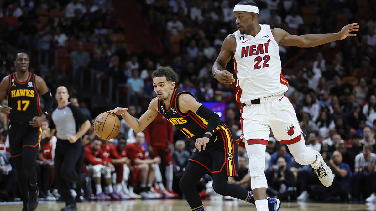 Atlanta Hawks guard Trae Young (11) dribbles the ball past Miami Heat forward Jimmy Butler (22) during the first quarter at Kaseya Center.