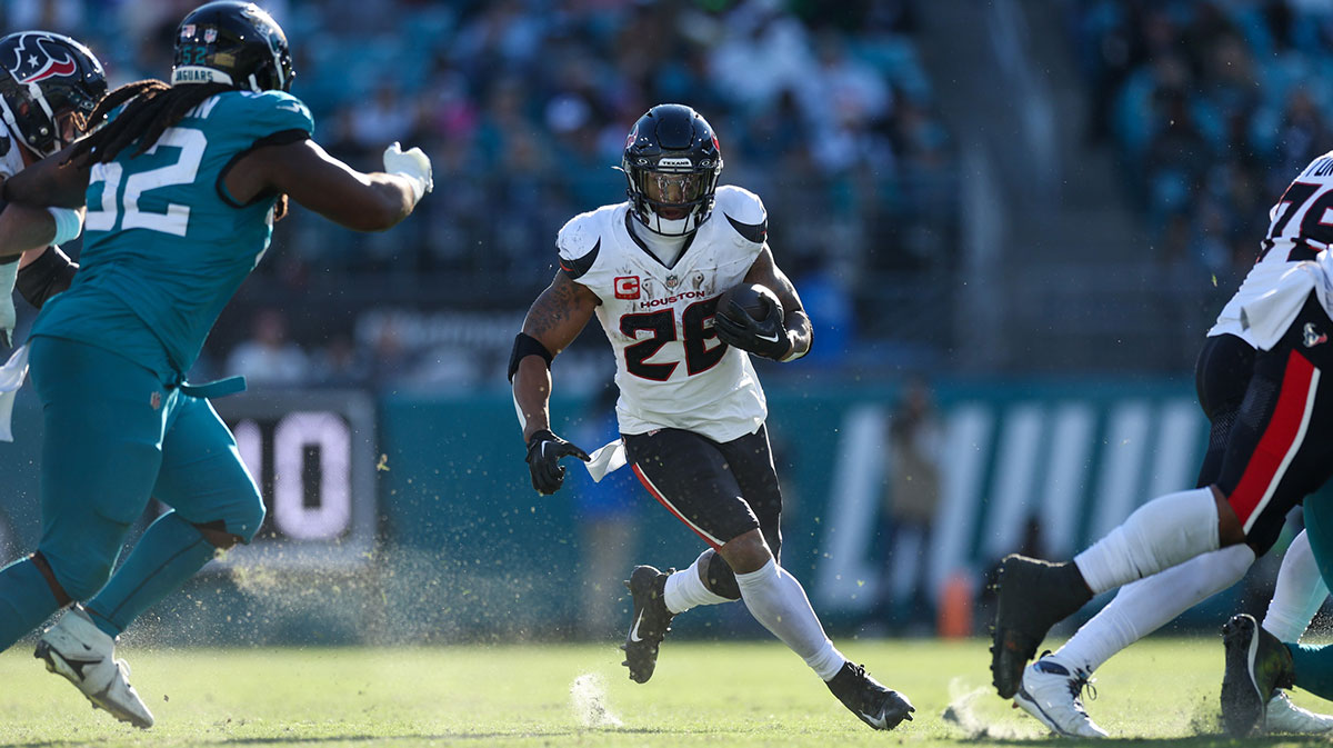 Dec 1, 2024; Jacksonville, Florida, USA; Houston Texans running back Joe Mixon (28) runs with the ball against the Jacksonville Jaguars in the third quarter at EverBank Stadium. 