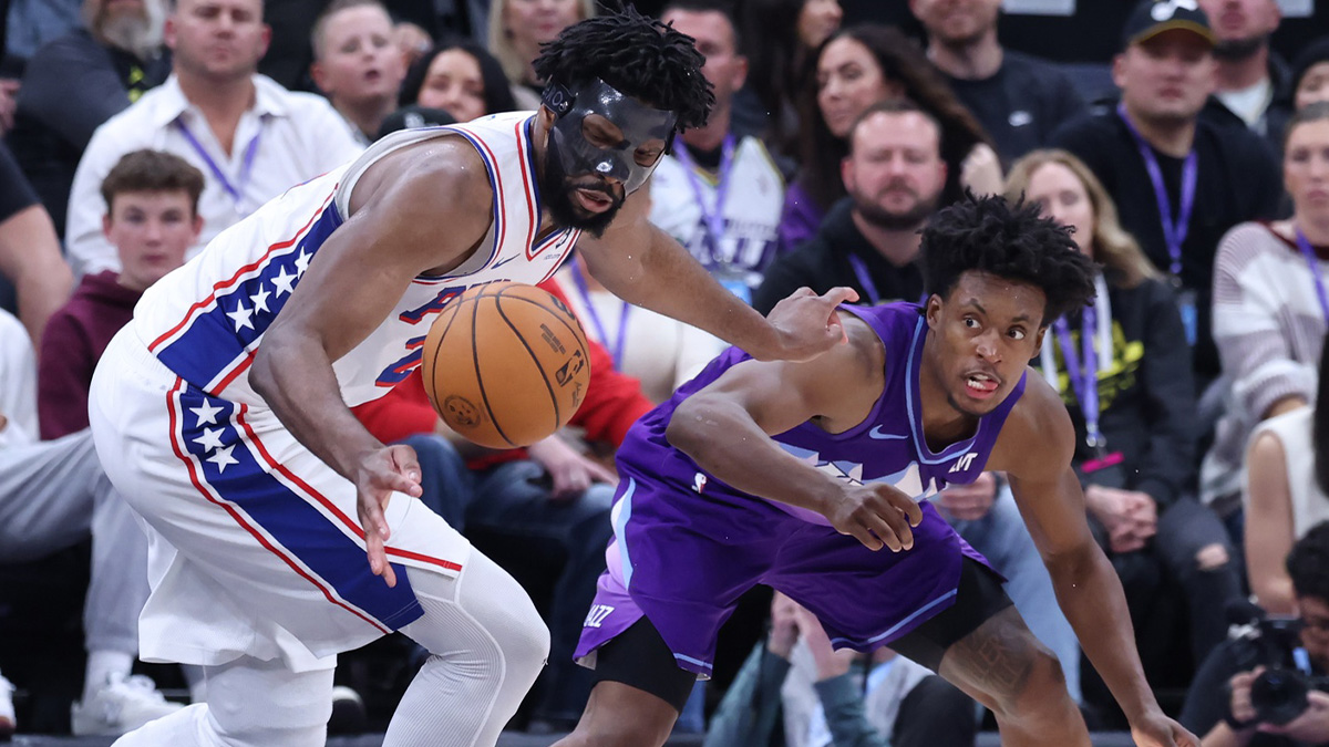 Philadelphia 76ers center Joel Embiid (21) and Utah Jazz guard Colin Sexton (2) reach for a loose ball during the fourth quarter at the Delta Center.