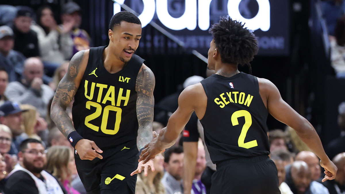 Utah Jazz forward John Collins (20) and guard Collin Sexton (2) react to a play against the Atlanta Hawks during the first quarter at Delta Center.