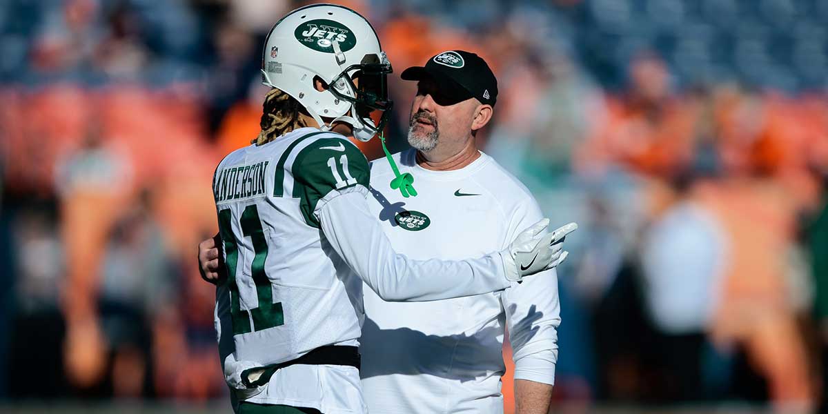 Jets wide receiver Robby Anderson (11) talks with offensive coordinator John Morton before the game against the Denver Broncos at Sports Authority Field at Mile High. 