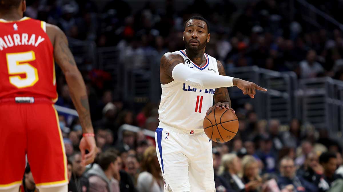 Los Angeles Clippers guard John Wall (11) dribbles the ball against Atlanta Hawks guard Dejounte Murray (5) during the fourth quarter at Crypto.com Arena.