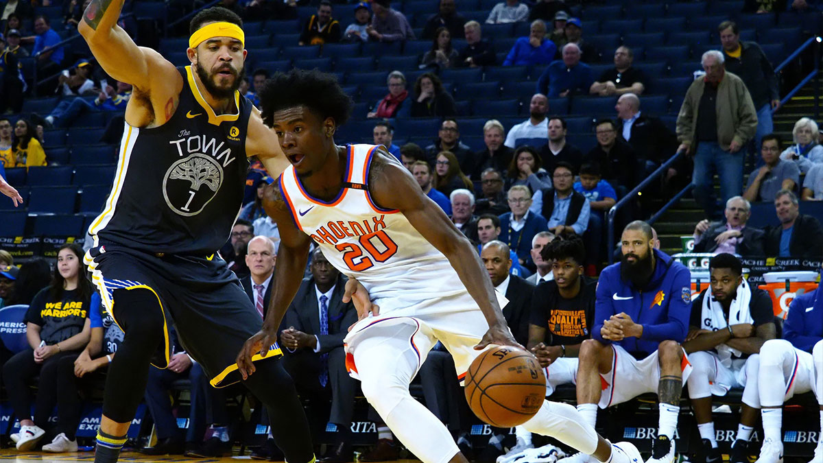 Phoenix Suns forward Josh Jackson (20) drives in against Golden State Warriors center JaVale McGee (1) during the fourth quarter at Oracle Arena.