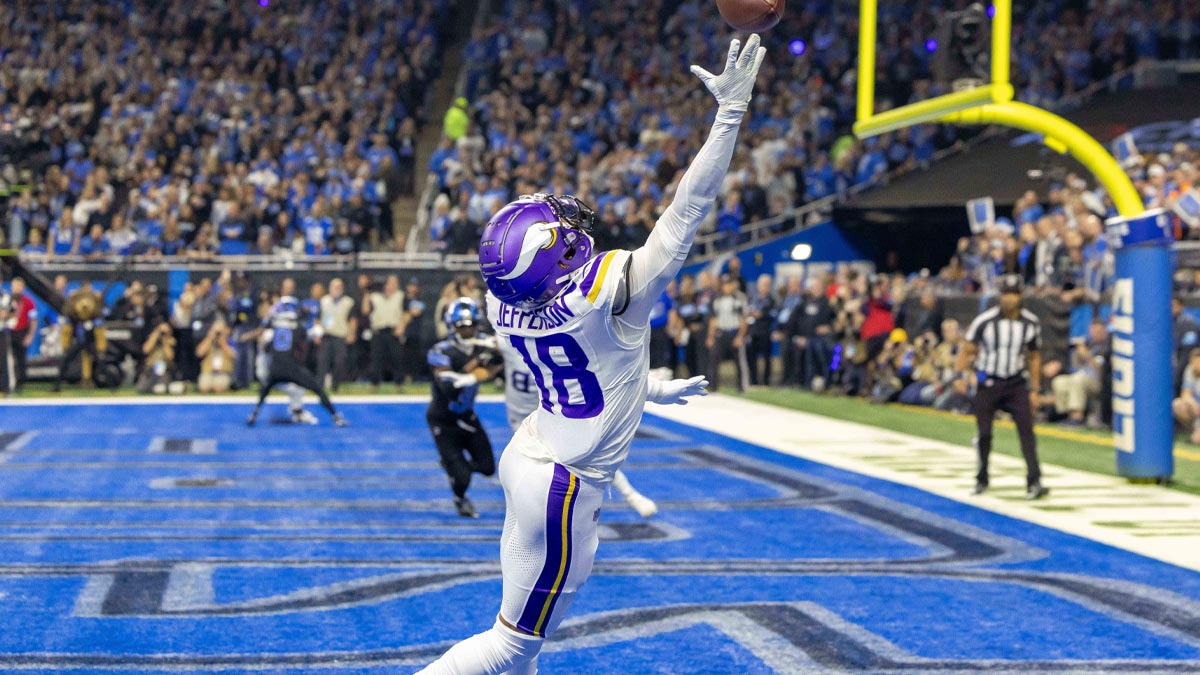 Minnesota Vikings wide receiver Justin Jefferson (18) attempts to pull in a pass in front of Detroit Lions cornerback Amik Robertson (21) during the first half at Ford Field.