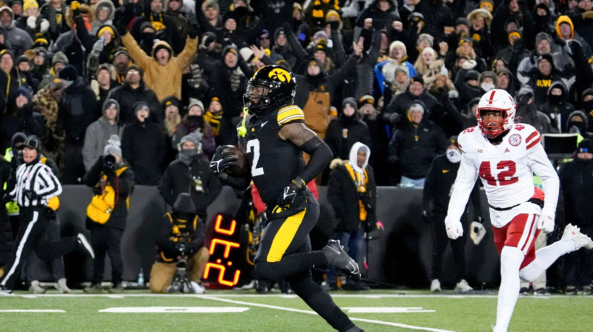 Iowa Hawkeyes running back Kaleb Johnson (2) runs to the endzone to score a touchdown as DUPLICATE***Nebraska Cornhuskers linebacker Mikai Gbayor (42) trails Friday, Nov. 29, 2024 at Kinnick Stadium in Iowa City, Iowa.