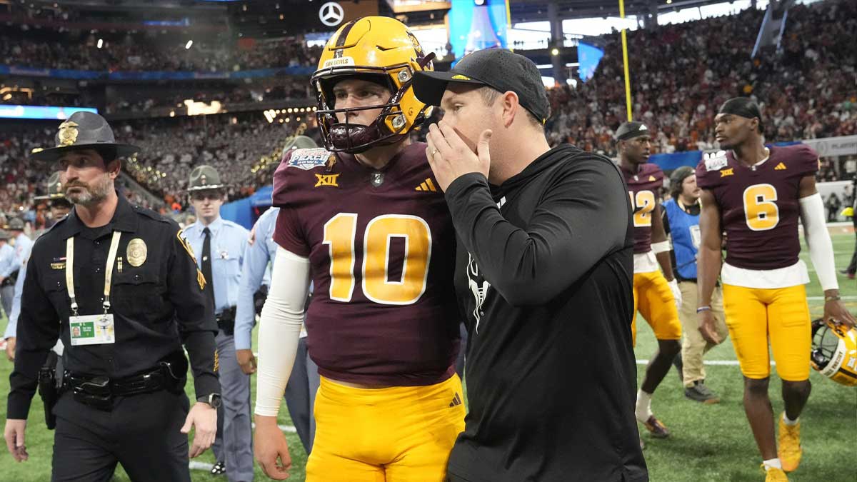 Arizona State head coach Kenny Dillingham whispers to quarterback Sam Leavitt (10) after Texas won 39-31 over Arizona State in double overtime in the Chick-fil-A Peach Bowl