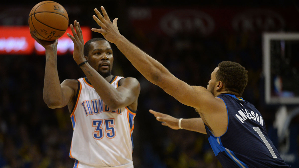 Oklahoma City Thunder Forward Kevin Durant (35) Holds the ball against Dallas Mavericks Guard Justin Andersona (1) during the fourth quarter in Chesapeake energy arena. 