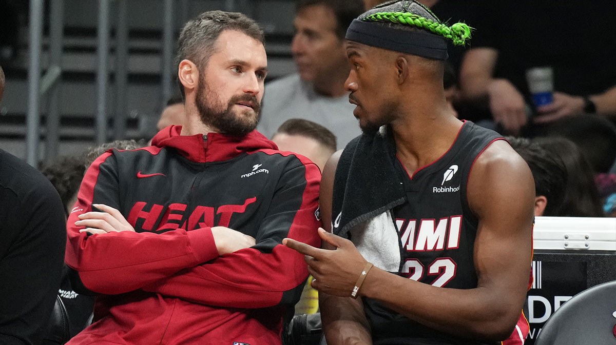 Miami Heat forward Jimmy Butler (22) talks with forward Kevin Love (42) on the bench during the second half against the Indiana Pacers at the Casey Center. 