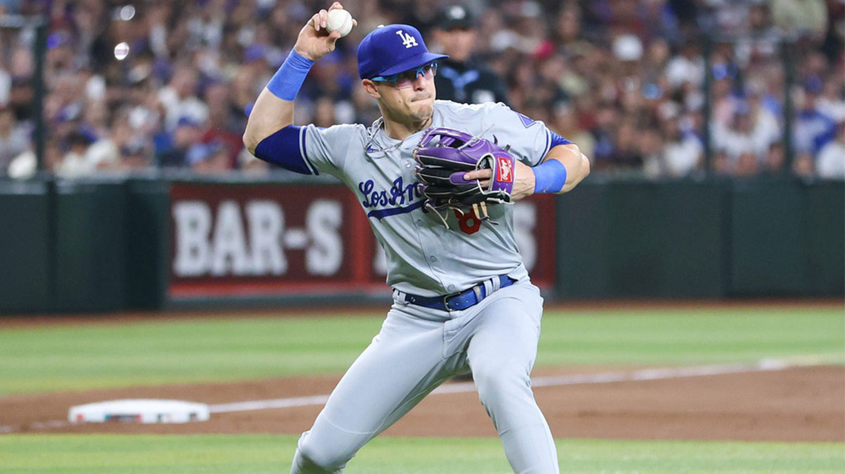 Los Angeles Dodgers infielder Kike Hernandez throws to first on a bunt