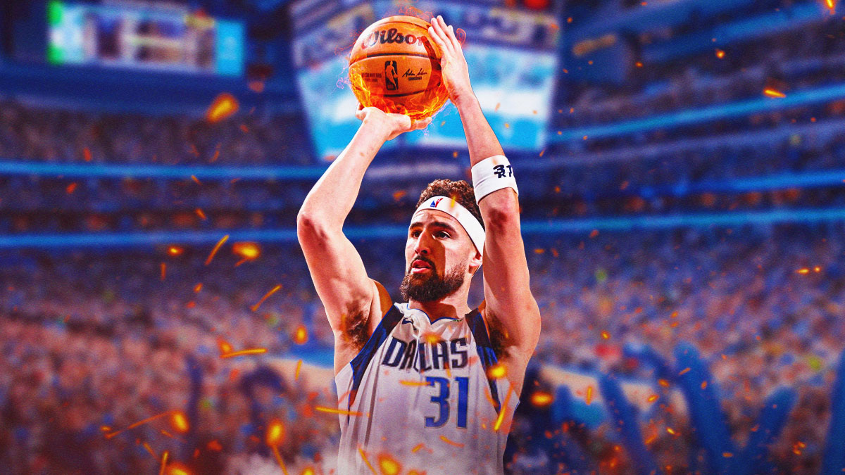 Mavericks Klay Thompson shooting a basketball with fire coming off the ball.