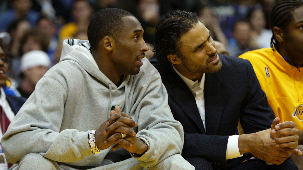 Injured Lakers' Kobe Bryant (left) and Rick Fox watch teammates during second half action of Los Angeles' 97 - 71 win over Denver at Staples Center. 